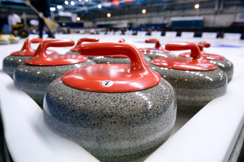Group of curling rocks on ice